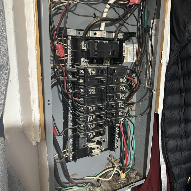 Electrical subpanel with wiring and corrosion damage