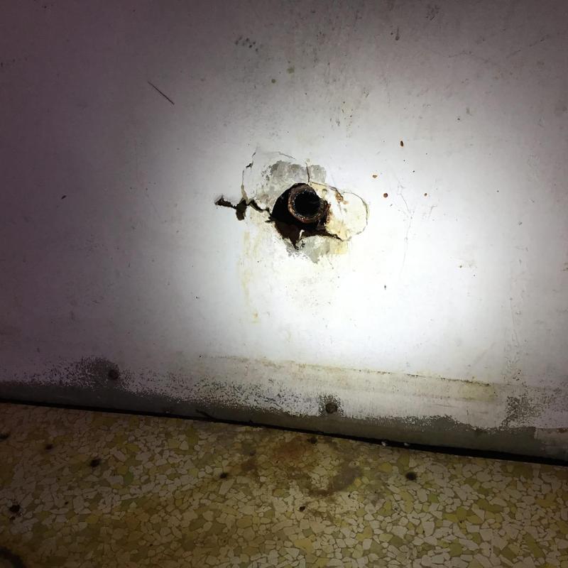Corroded sink trap pipe with wall damage