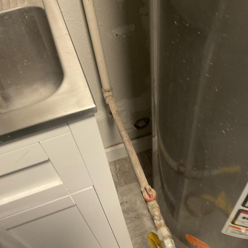 Gas line piping next to kitchen sink and water heater