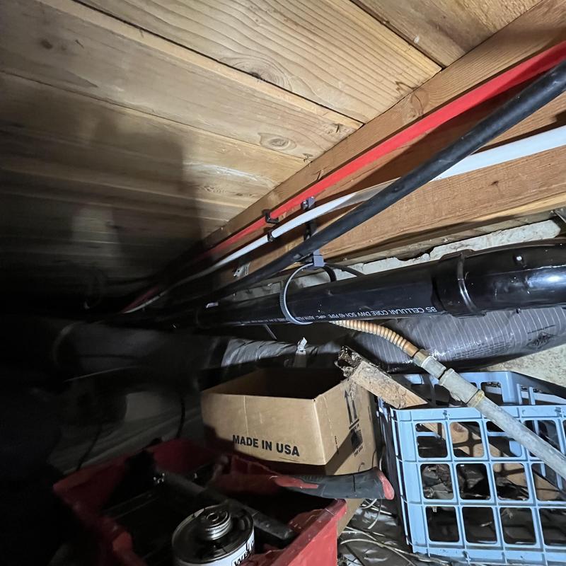 Kitchen sink drain pipe rerouted in crawl space