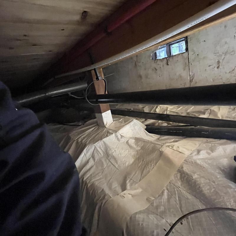 Kitchen sink drain pipes in crawl space with tarp