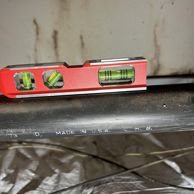 Kitchen sink drain pipe with level tool on top