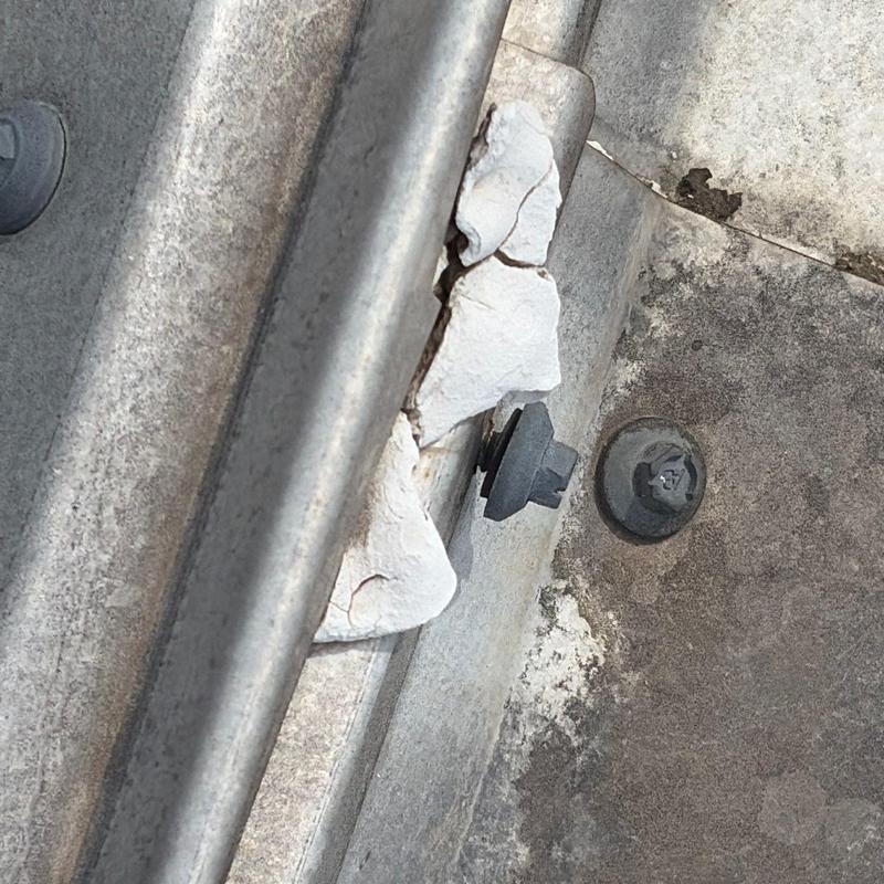 Standing seam metal roof panel splice with sealant damage