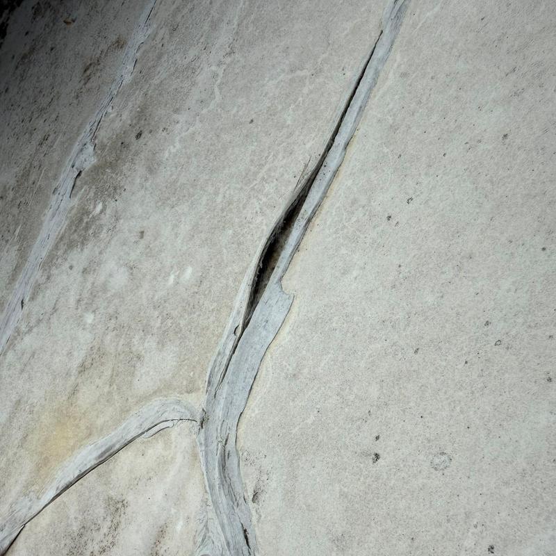 Standing seam metal roof splice leak gap close-up