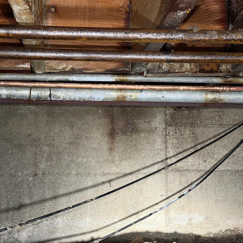 Copper water supply pipes in crawlspace with leak damage Copper water supply pipes in crawlspace with leak damage