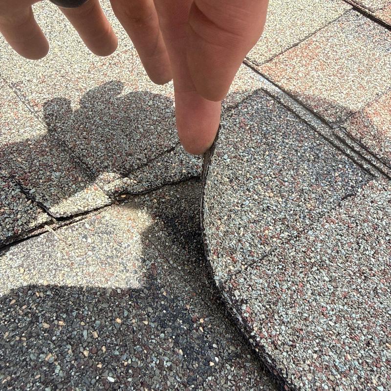 Asphalt shingles lifting from nail pops on roof valley
