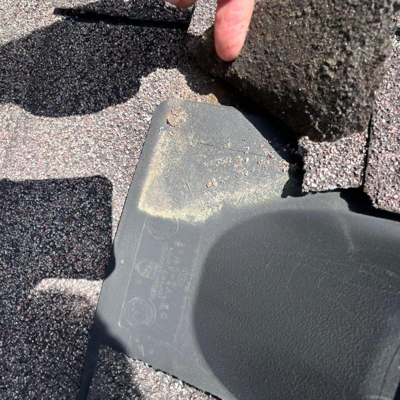 Dryer vent flashing with missing shingles and rusted screw