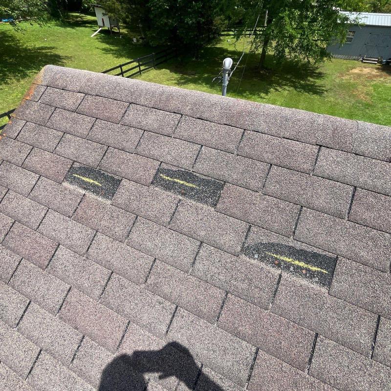 Asphalt shingles with marked granule loss on roof surface