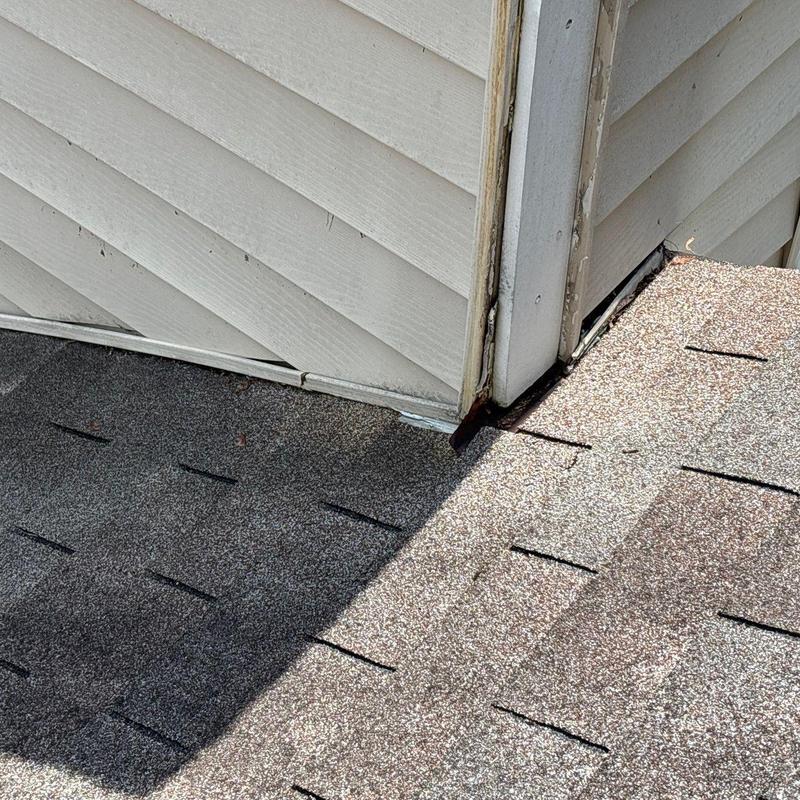 Chimney flashing separation with fascia damage on roof edge