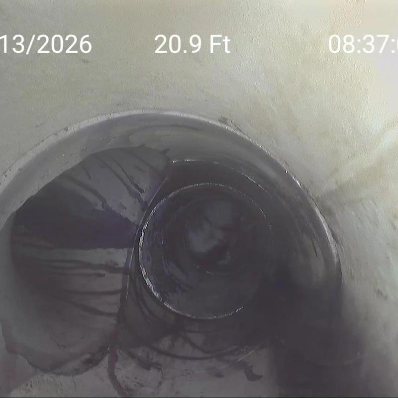 Sewer pipe interior with visible crack and debris