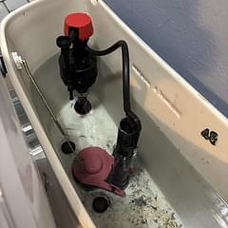 Toilet tank fill valve and flapper assembly inside tank