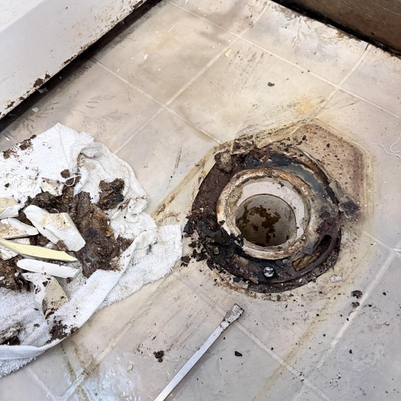 Toilet flange replacement with debris on floor