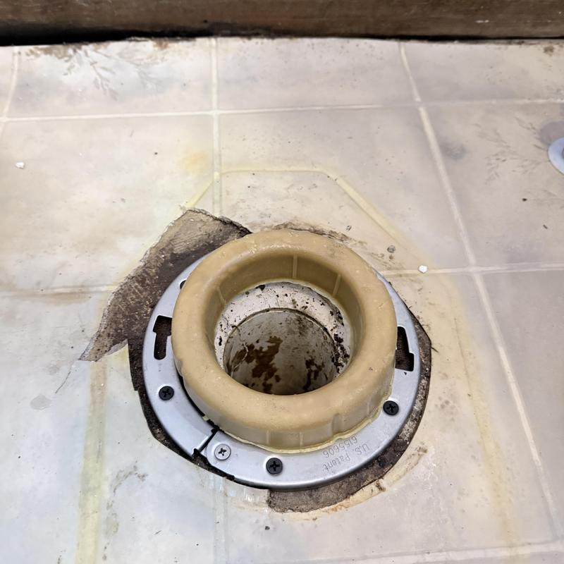 Toilet flange installation on tiled bathroom floor