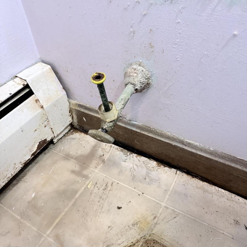Toilet supply valve and flange removed from wall