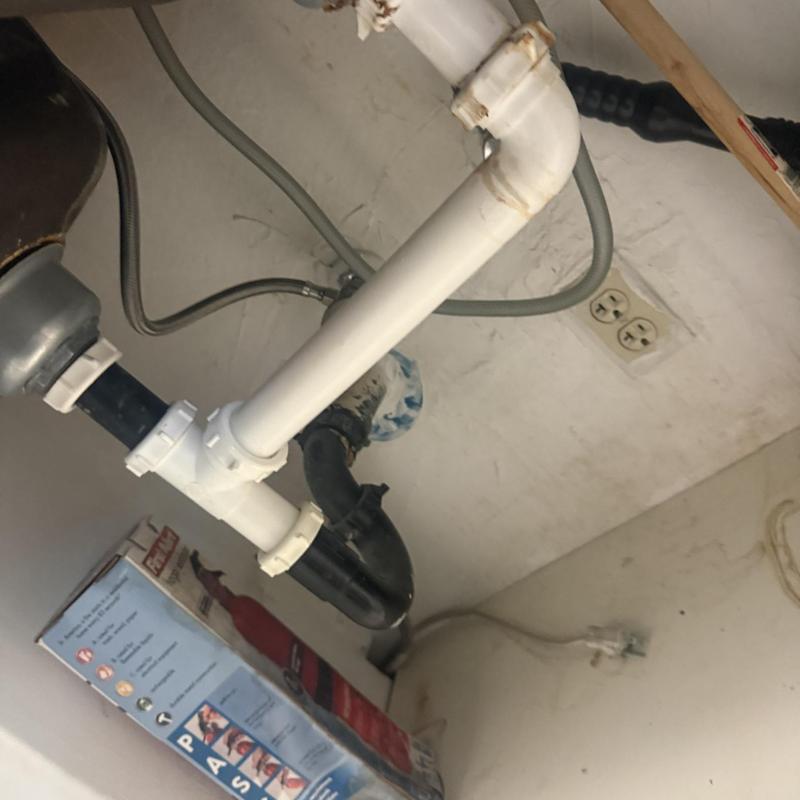 PVC drain pipe installation under sink in Glendale, AZ