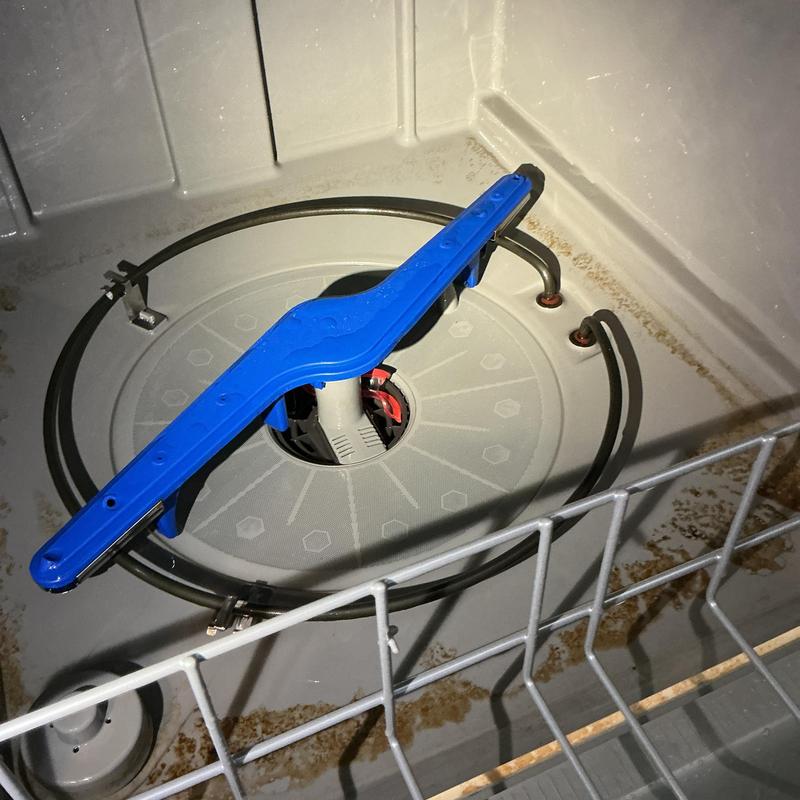 Dishwasher spray arm and interior with rust buildup