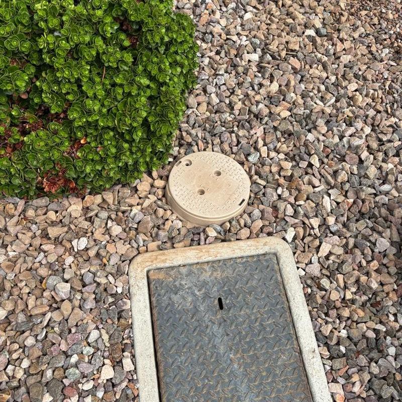 Pressure relief valve with tan access box on gravel ground Pressure relief valve with tan access box on gravel ground