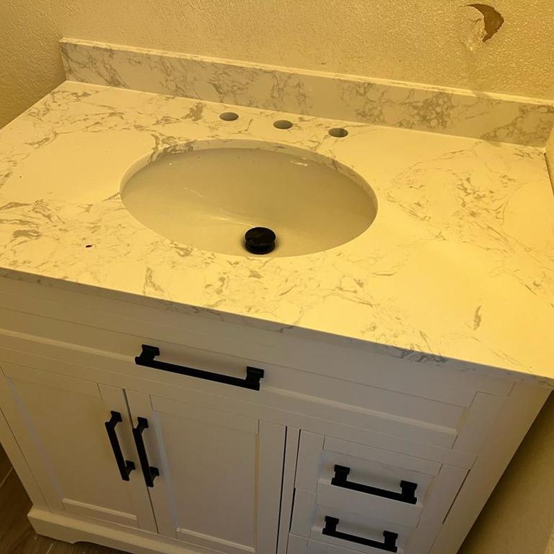 Bathroom vanity with marble countertop and sink installed Bathroom vanity with marble countertop and sink installed