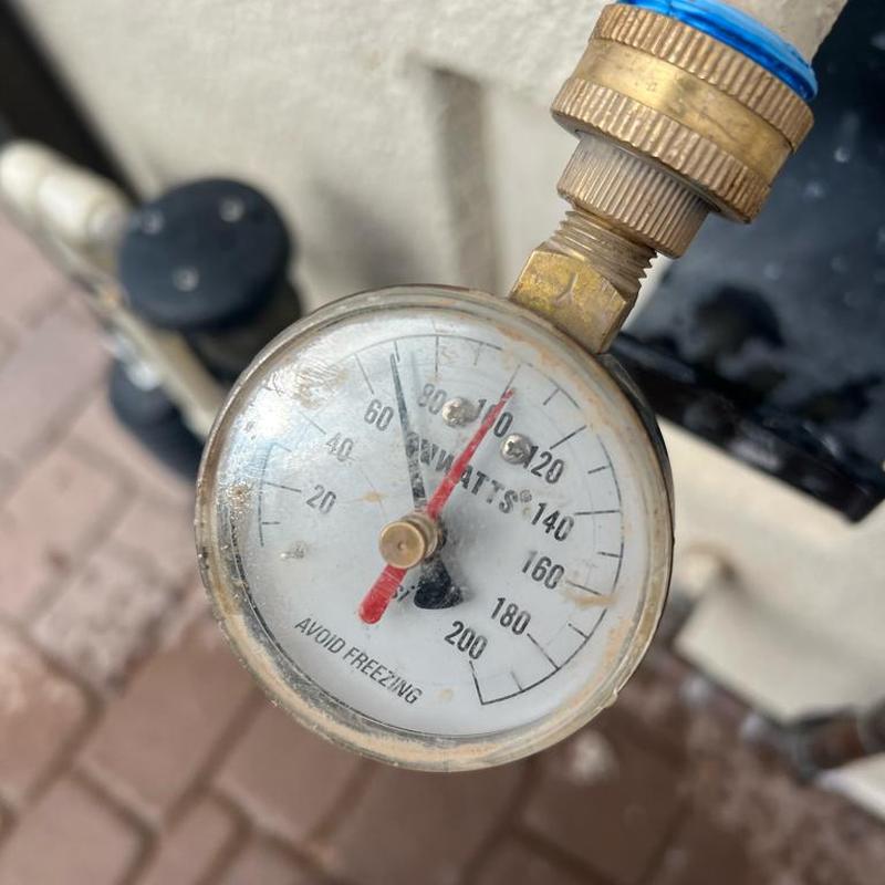 Pressure regulator valve gauge showing water pressure reading Pressure regulator valve gauge showing water pressure reading