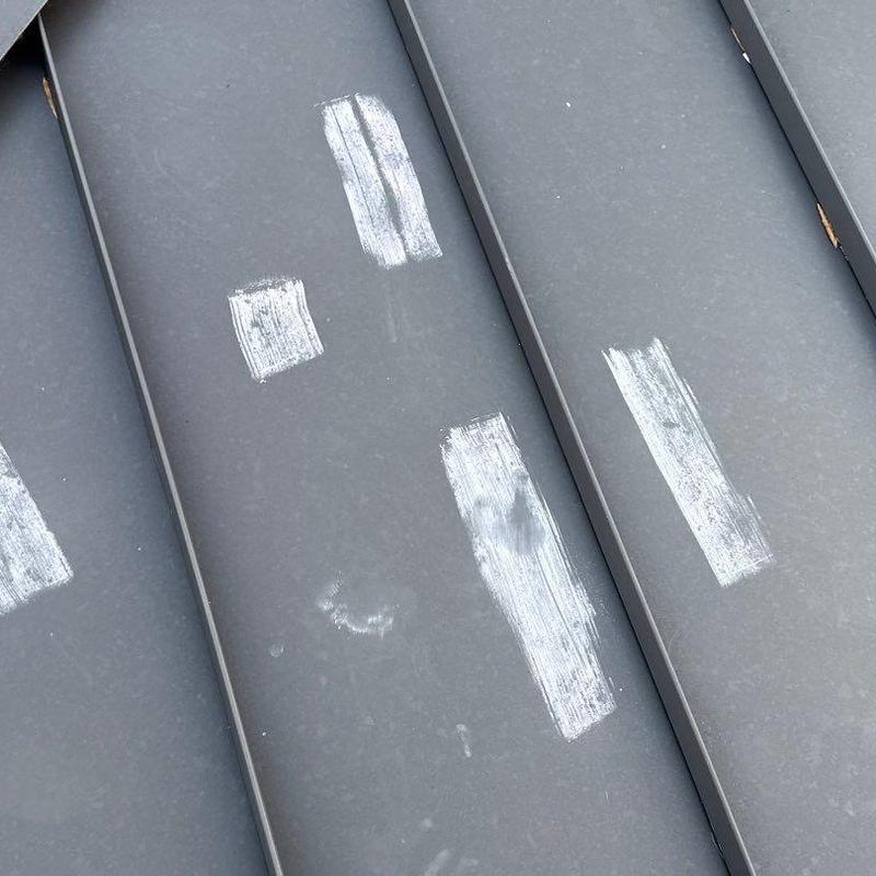Metal roof hail damage with marked scratches