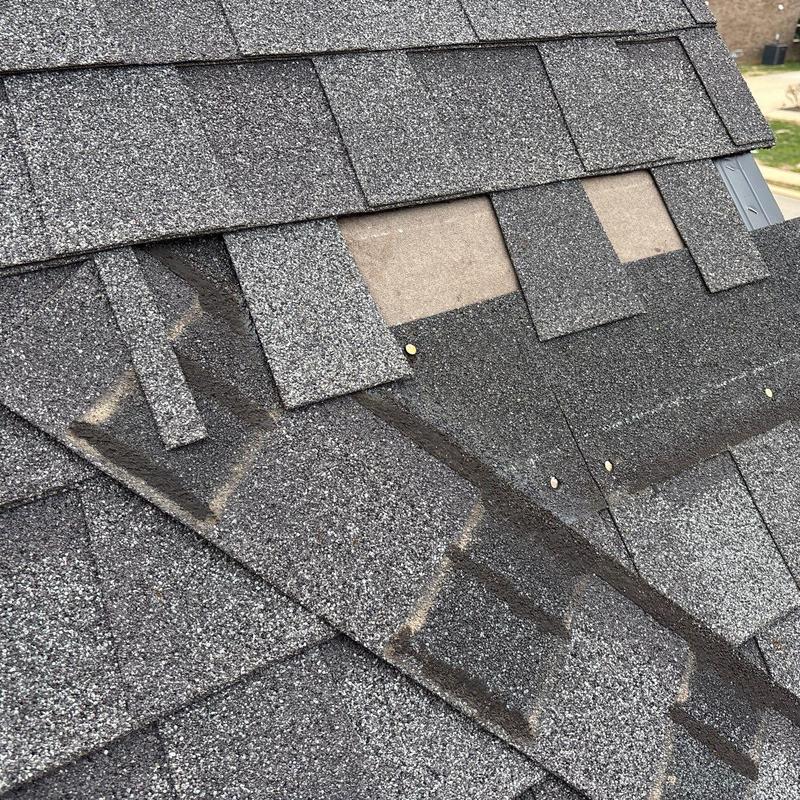 Asphalt shingles with hail damage and missing tabs