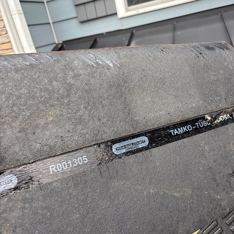 Asphalt shingle with hail damage close-up