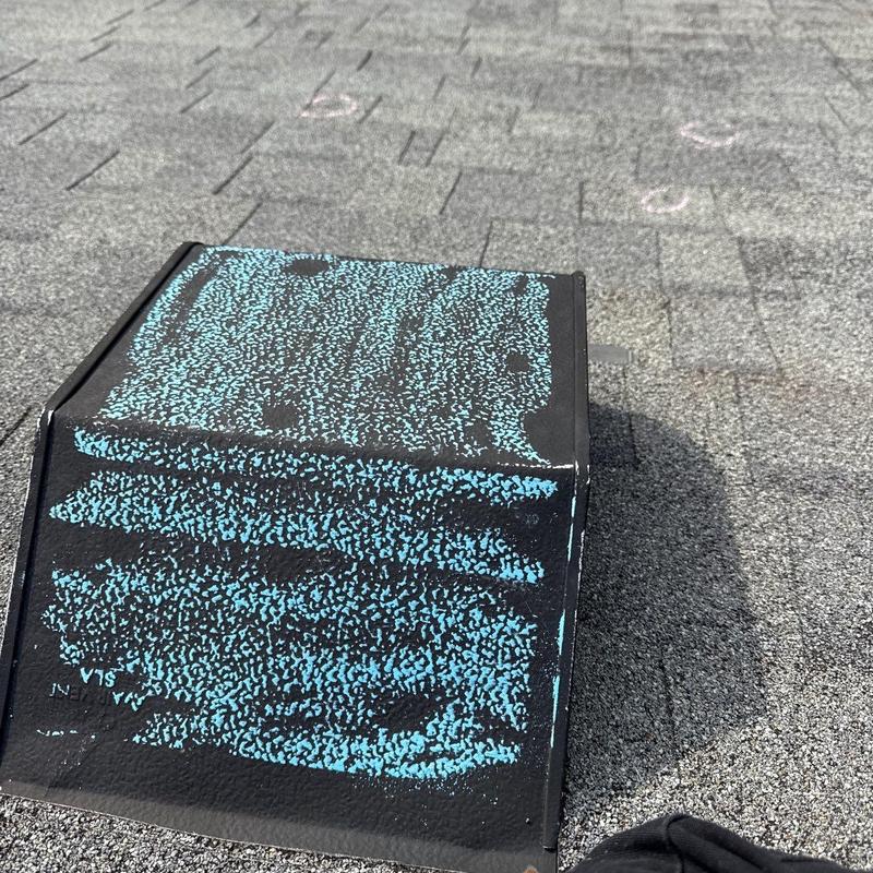 Roof flashing with hail damage markings on shingles