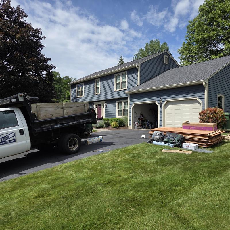 Asphalt shingle roof with roofing materials and truck Asphalt shingle roof with roofing materials and truck