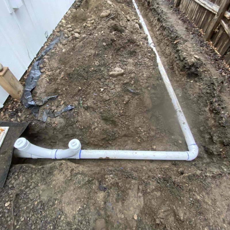 PVC pipe trenching alongside driveway and backyard