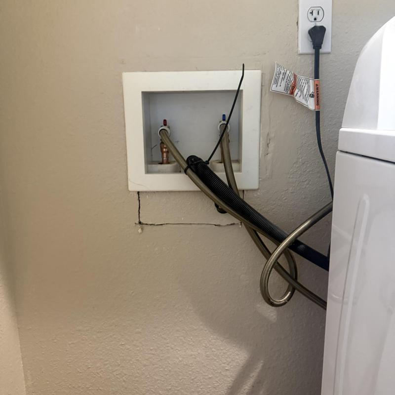 Laundry valve box with supply hoses and outlet