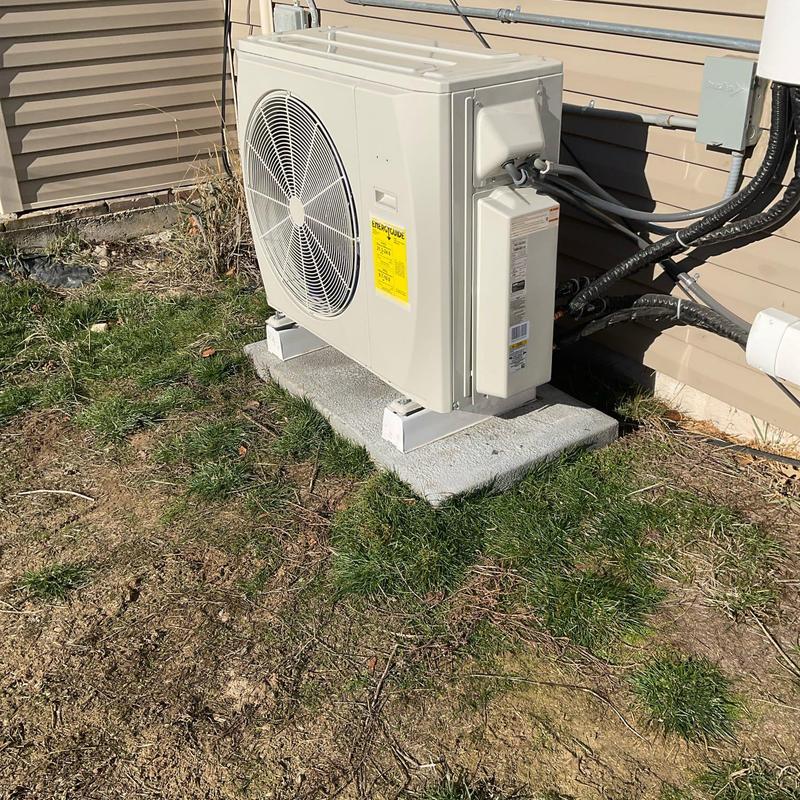 Outdoor mini split heat pump condenser unit on pad