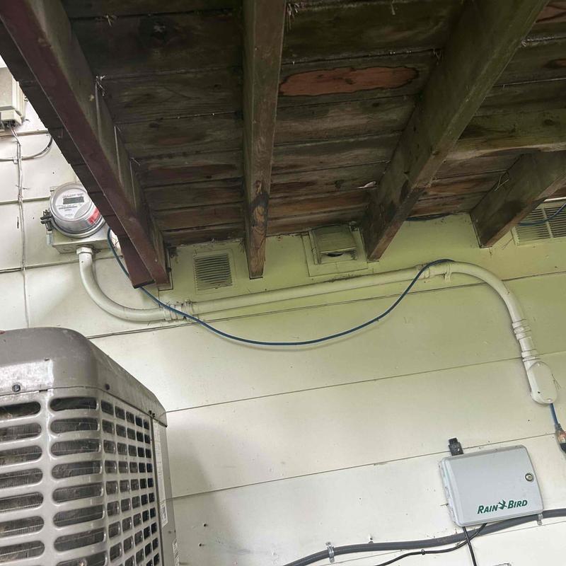 Electrical meter and outdoor panel under deck beams