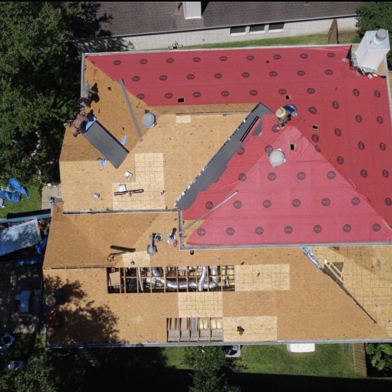 Synthetic roofing underlayment installation on residential roof