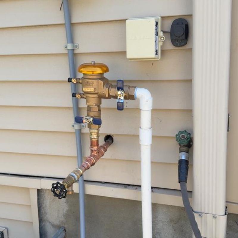 Irrigation vacuum breaker and piping on house exterior Irrigation vacuum breaker and piping on house exterior