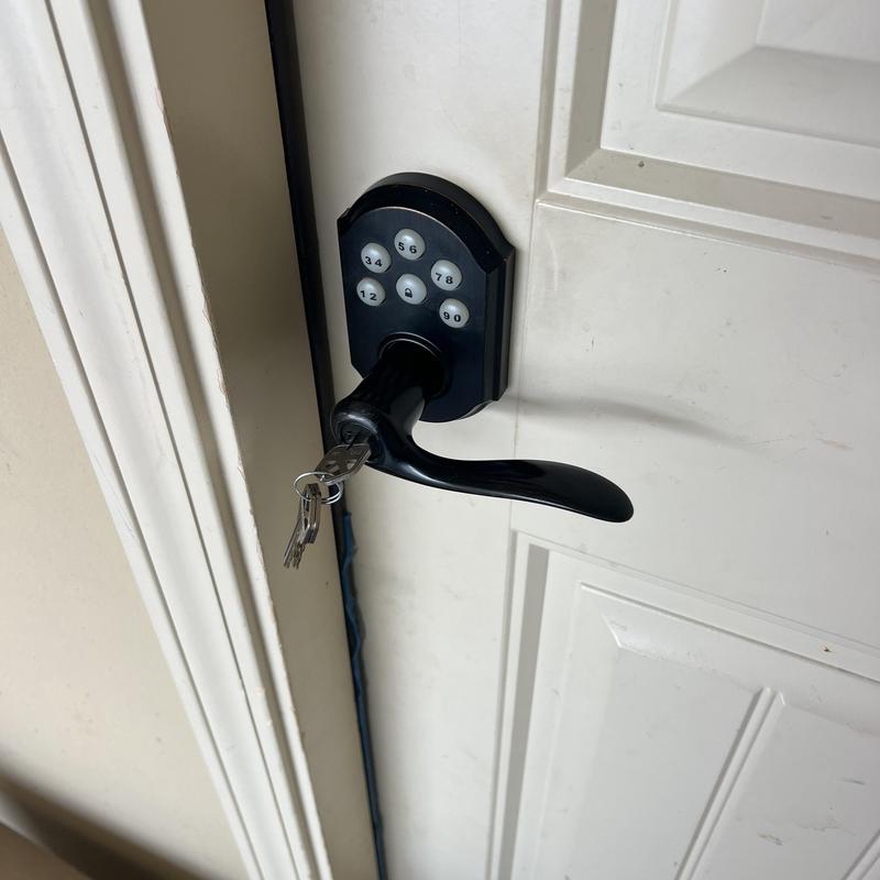 Electronic lever lock with keys on white door