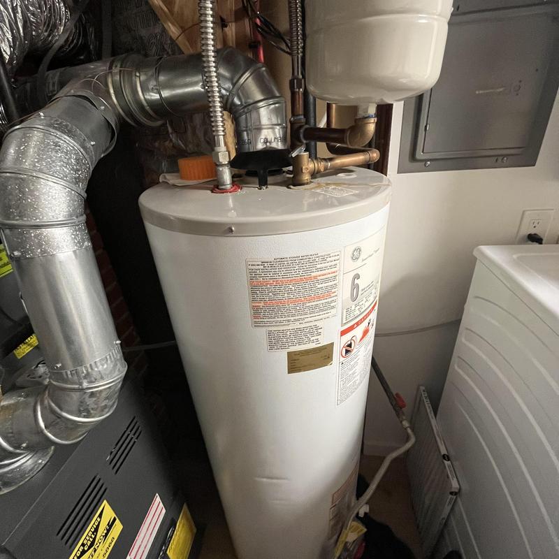 50 gallon gas water heater with vent pipe in basement