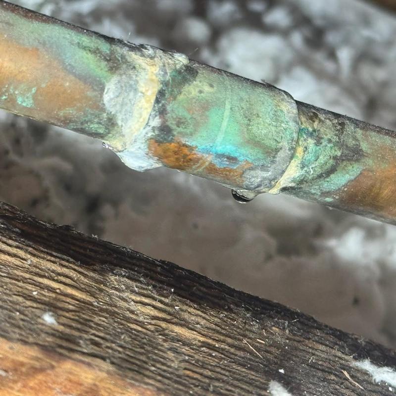 Copper water line with leak and corrosion buildup