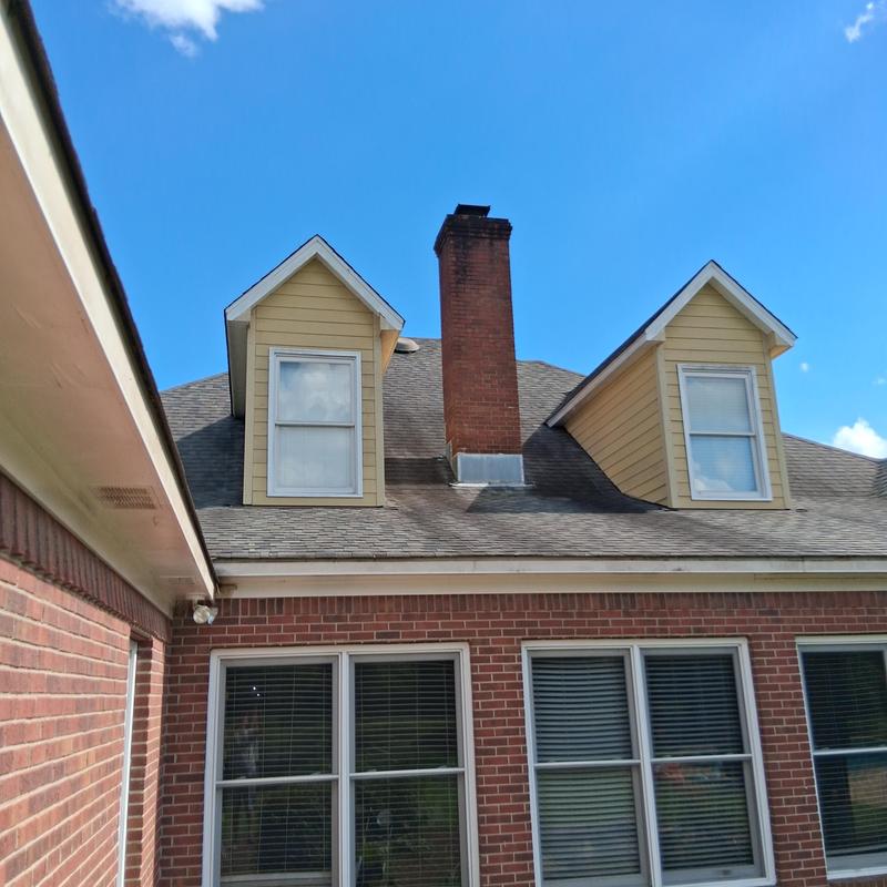 Siding soffit trim on brick house exterior