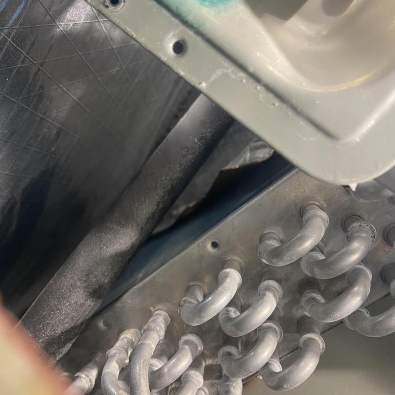 HVAC evaporator coil with frost buildup during inspection