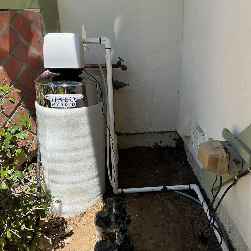 Water softener system installed on main water riser