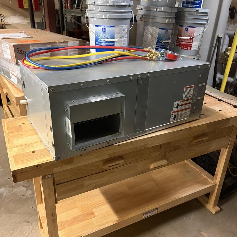 Heat pump unit on wooden workbench with manifold gauges Heat pump unit on wooden workbench with manifold gauges