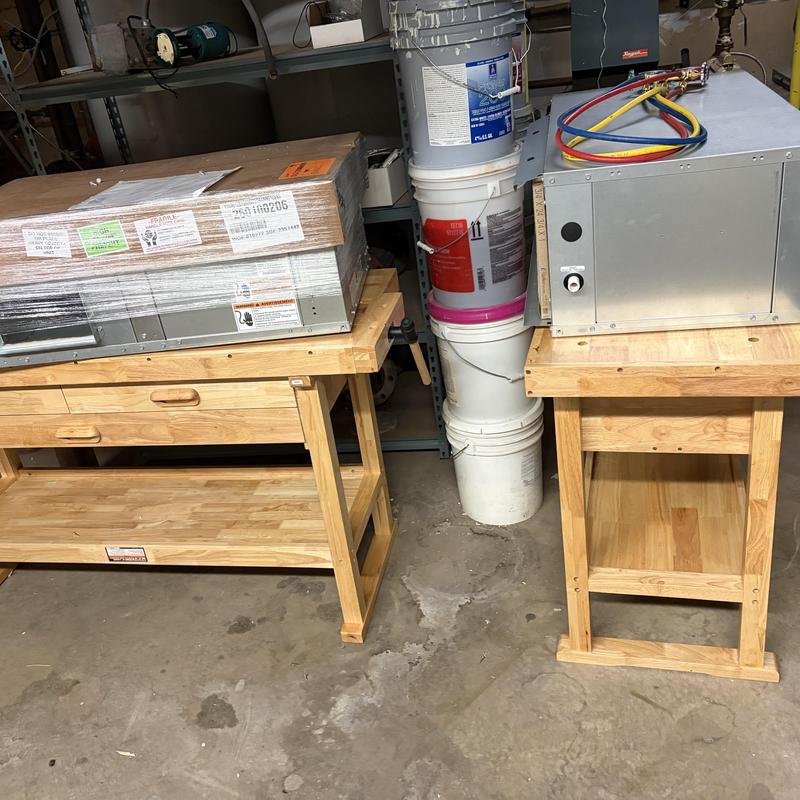 Heat pump units on workbenches in workshop Heat pump units on workbenches in workshop