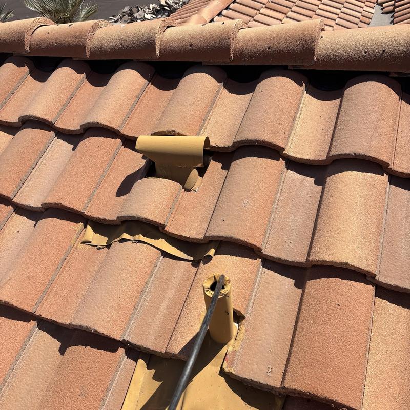 Clay tile roof with cracked and displaced tiles