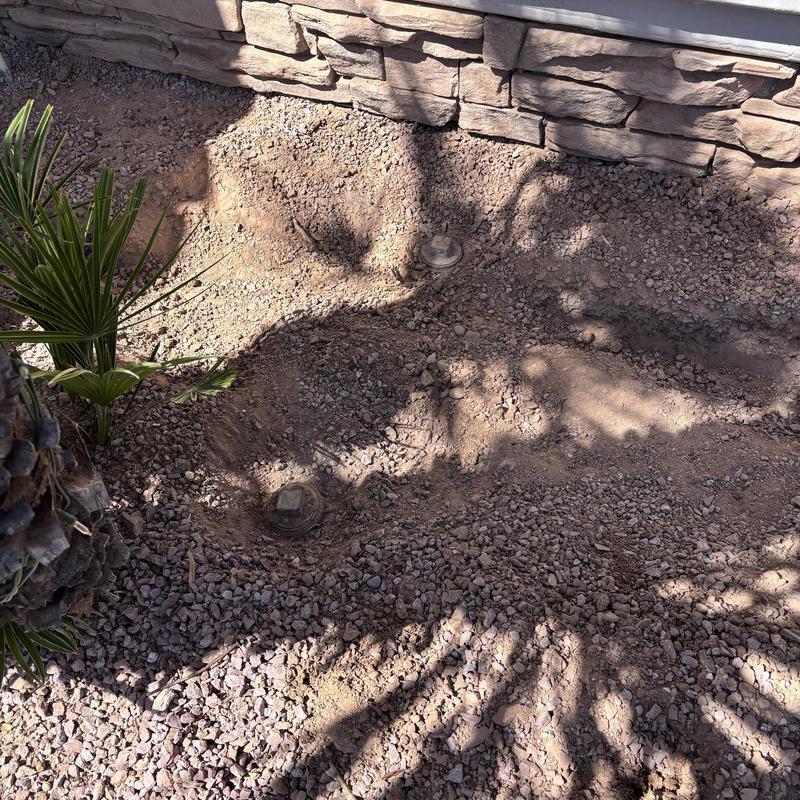 Sewer line access points in gravel landscaping