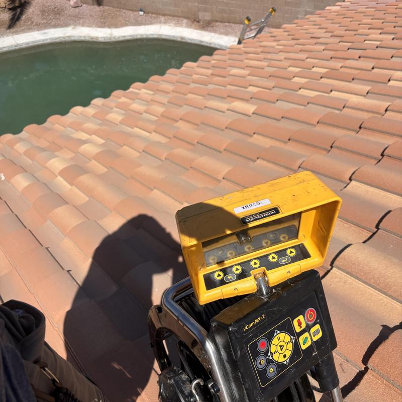 Sewer line inspection camera on roof tiles