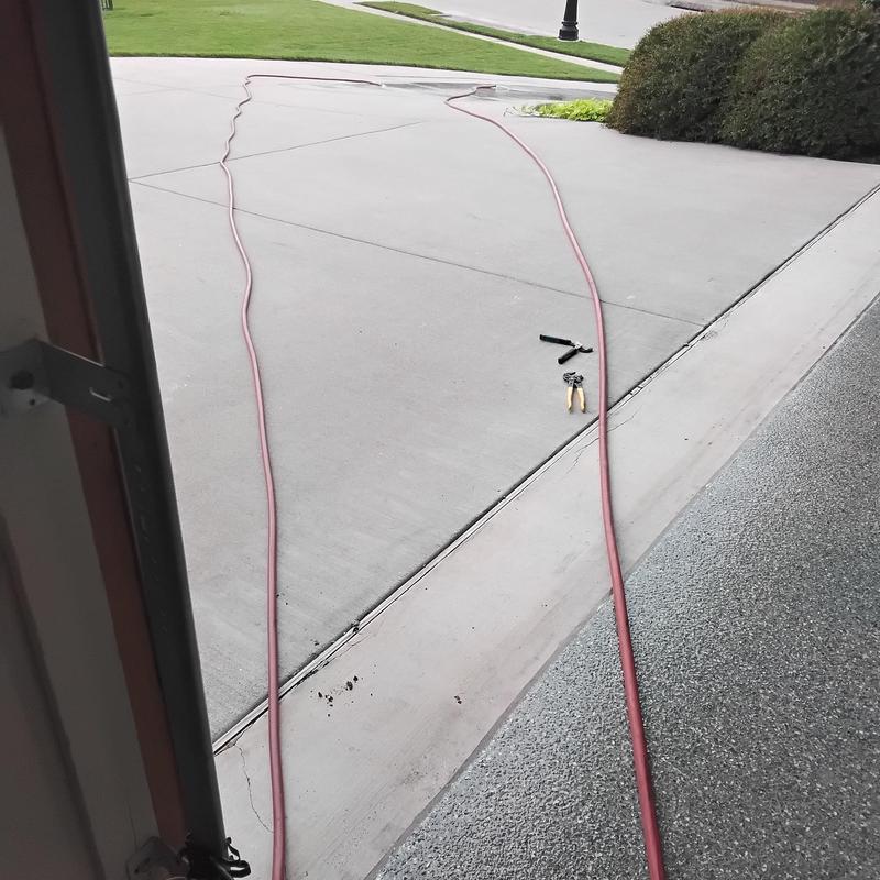 Water heater flushing hoses and tools on driveway