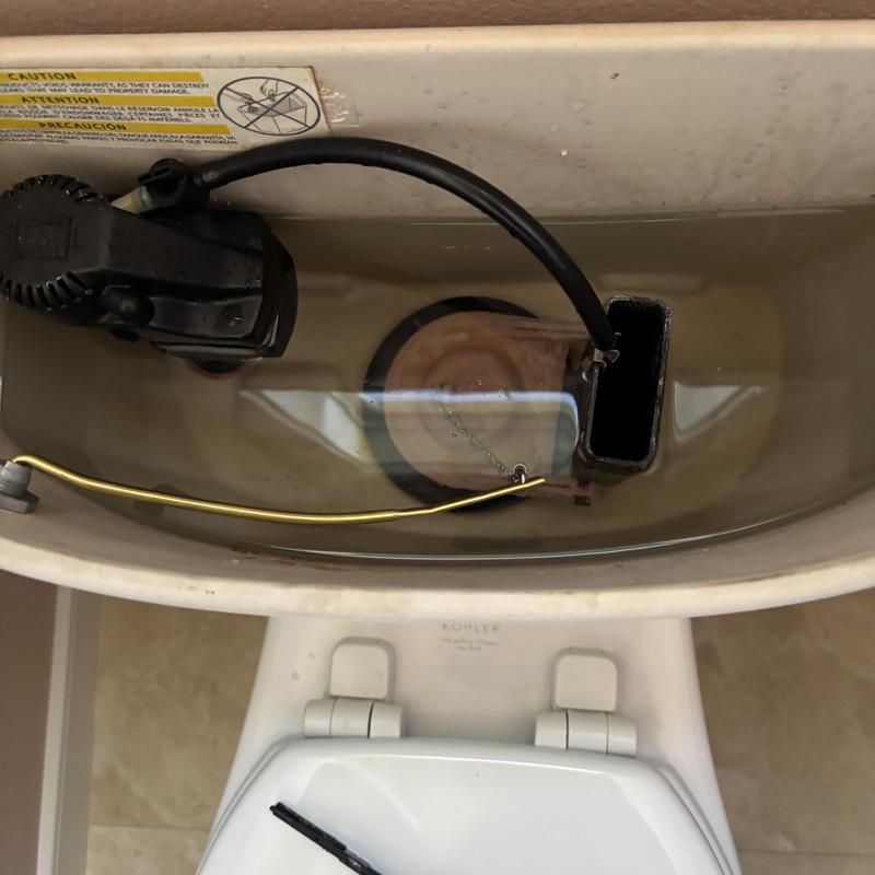 Toilet tank with new flush handle assembly installed Toilet tank with new flush handle assembly installed