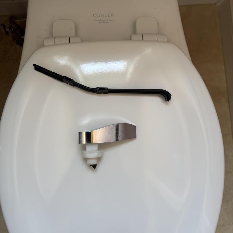 Toilet handle with broken lever removed on lid Toilet handle with broken lever removed on lid