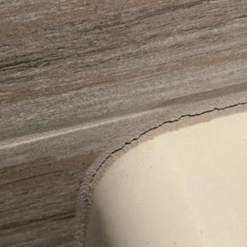 Tile grout crack along bathtub edge and tile wall