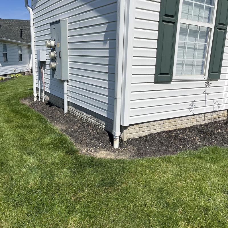 Vinyl siding and downspout on house corner